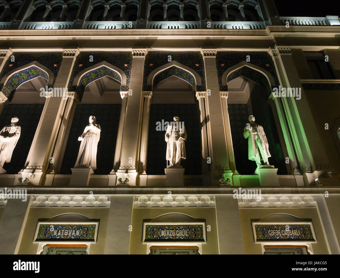 Nizami Museum of Azerbaijan Literature, night-time view of façade with statues of famous authors, in Baku Azerbaijan Stock Photo