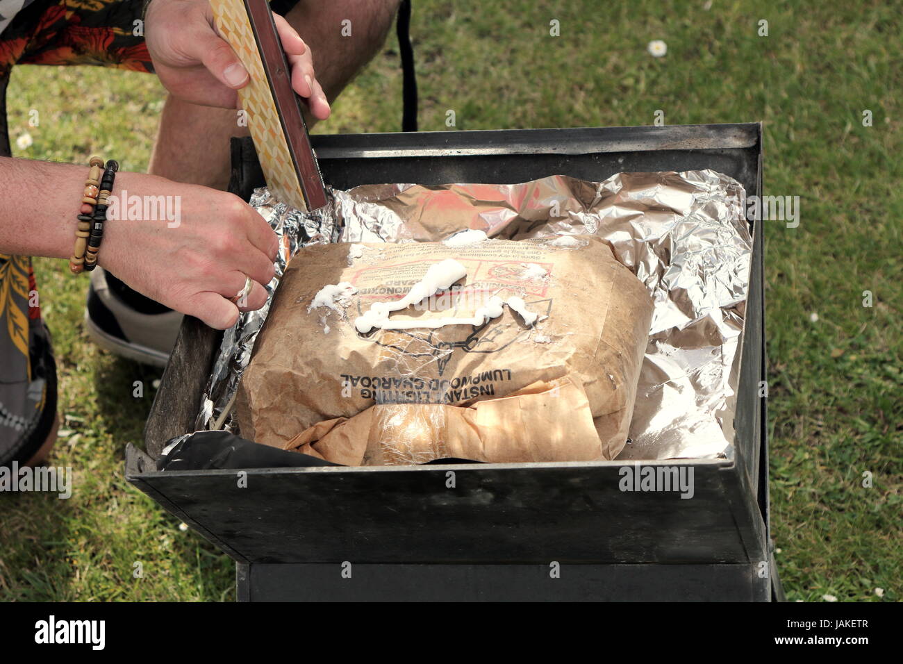 Lighting a bag of instant lighting lumpwood charcoal for a barbecue