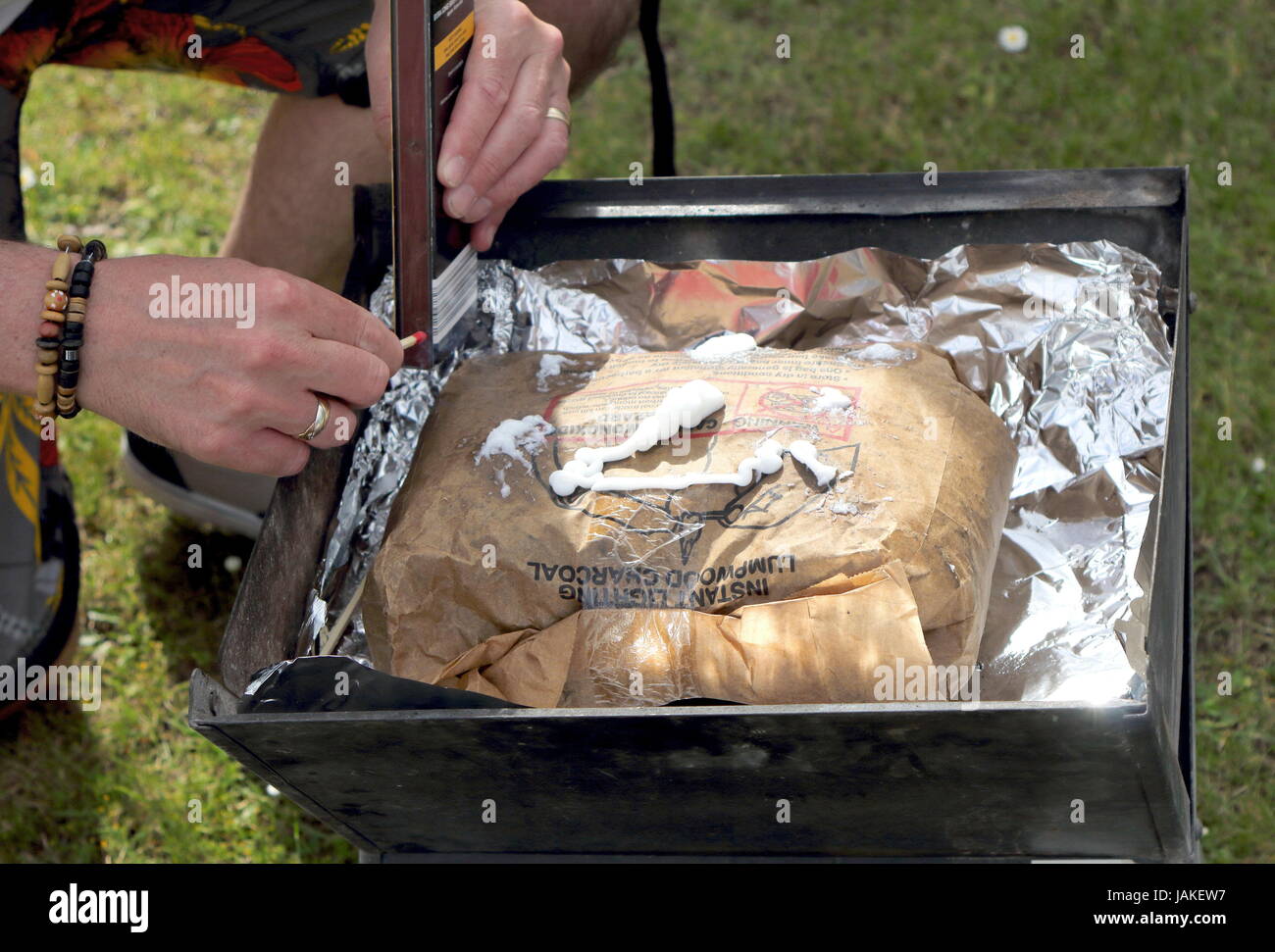 Lighting a bag of instant lighting lumpwood charcoal for a barbecue