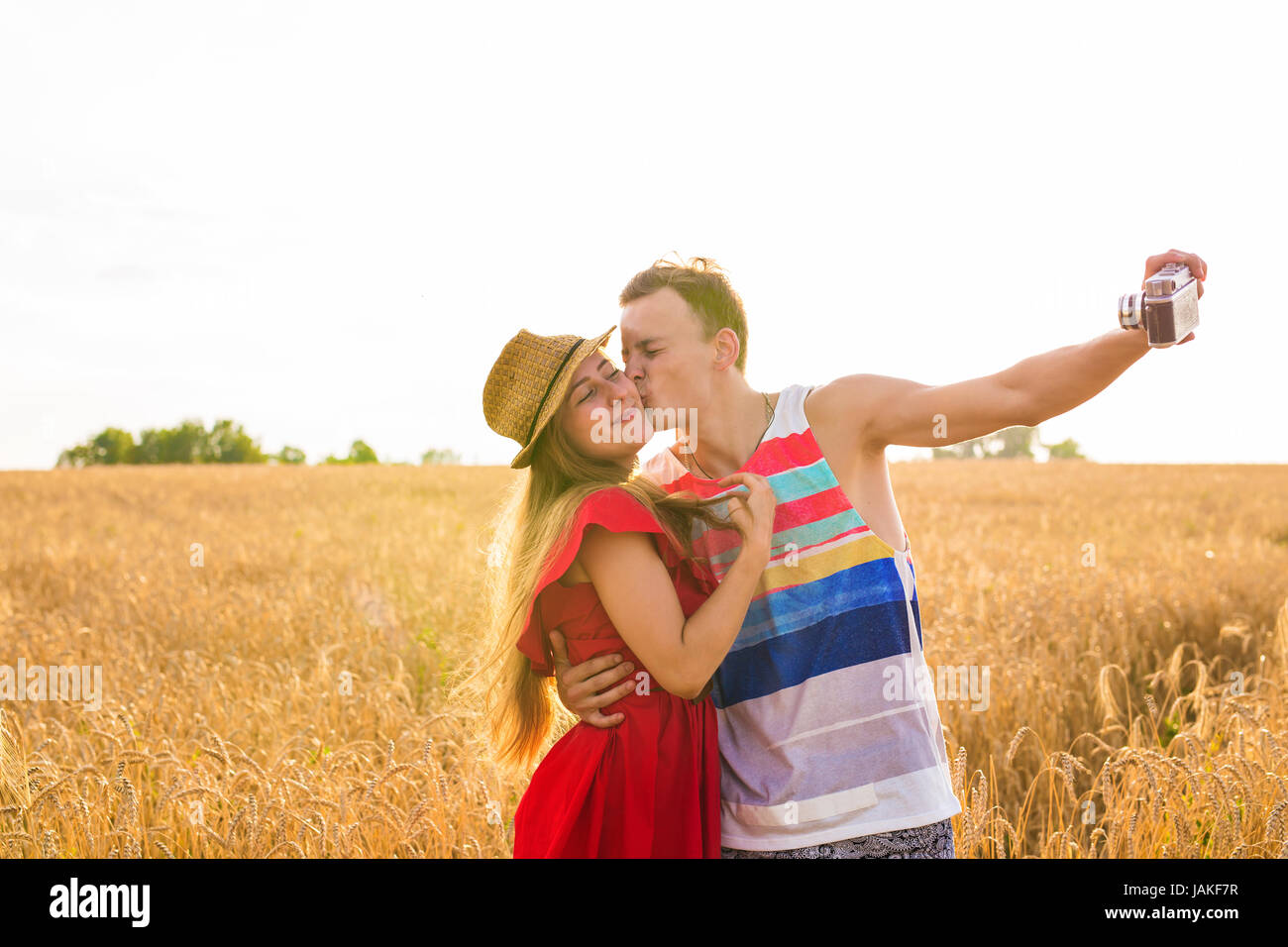 Young happy couple taking a selfie in the field Stock Photo - Alamy