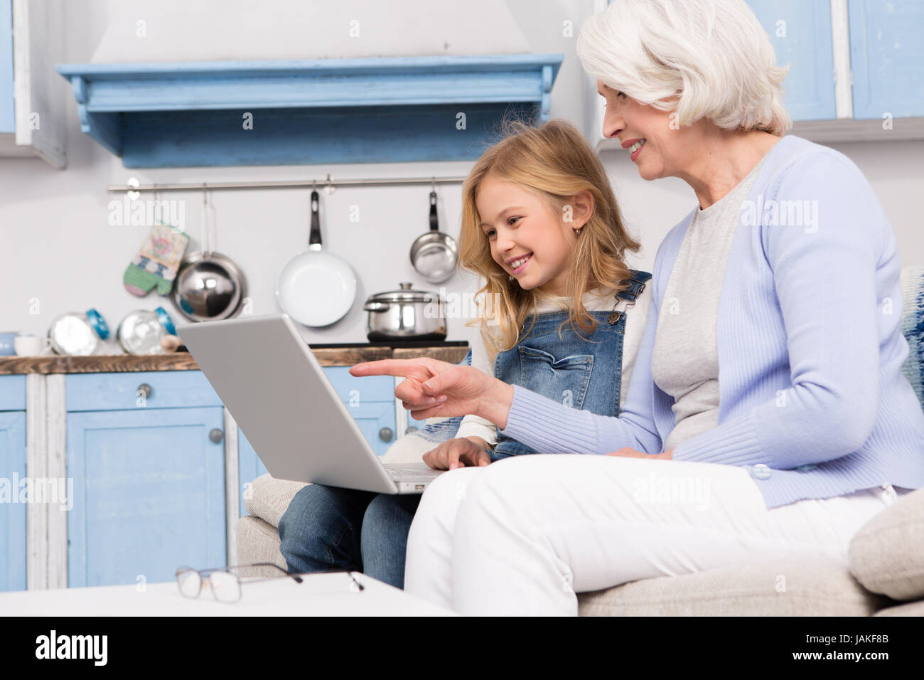 Granny and little girl using laptop Stock Photo - Alamy