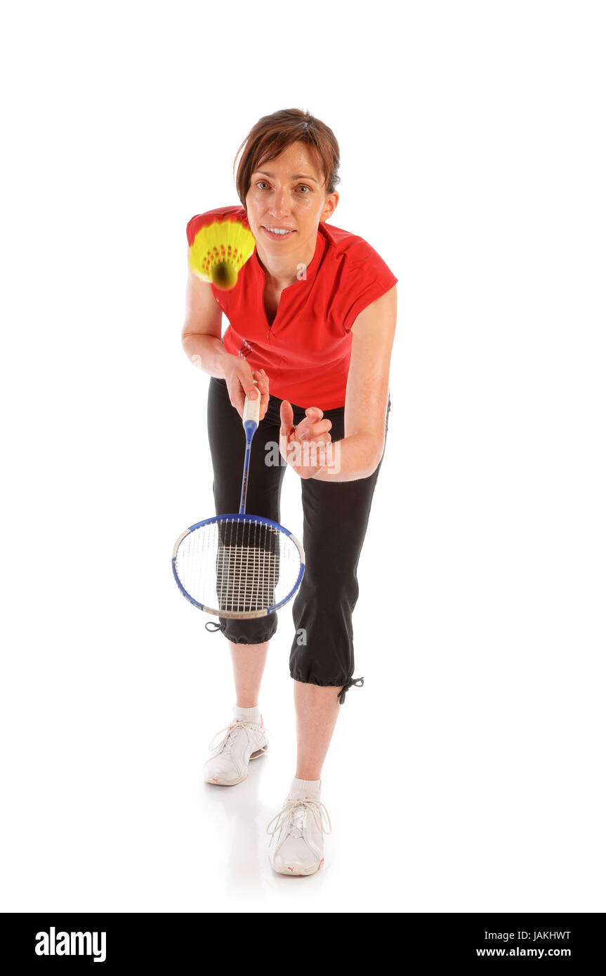 Junge Frau in Sportdress spielt Badminton (Federball) vor weißem Hintergrund Stock Photo