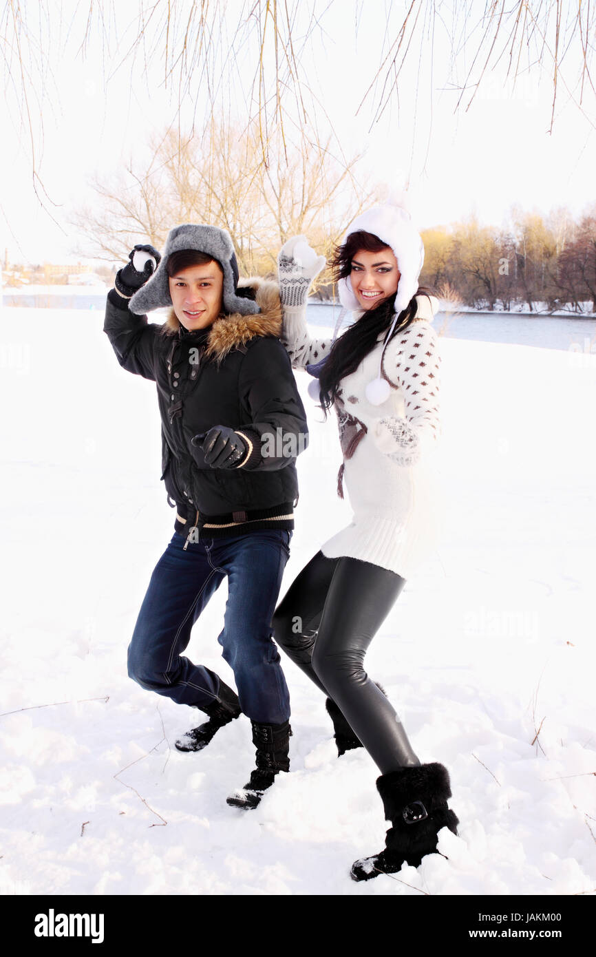 happy couple throwing snowballs in the park Stock Photo - Alamy
