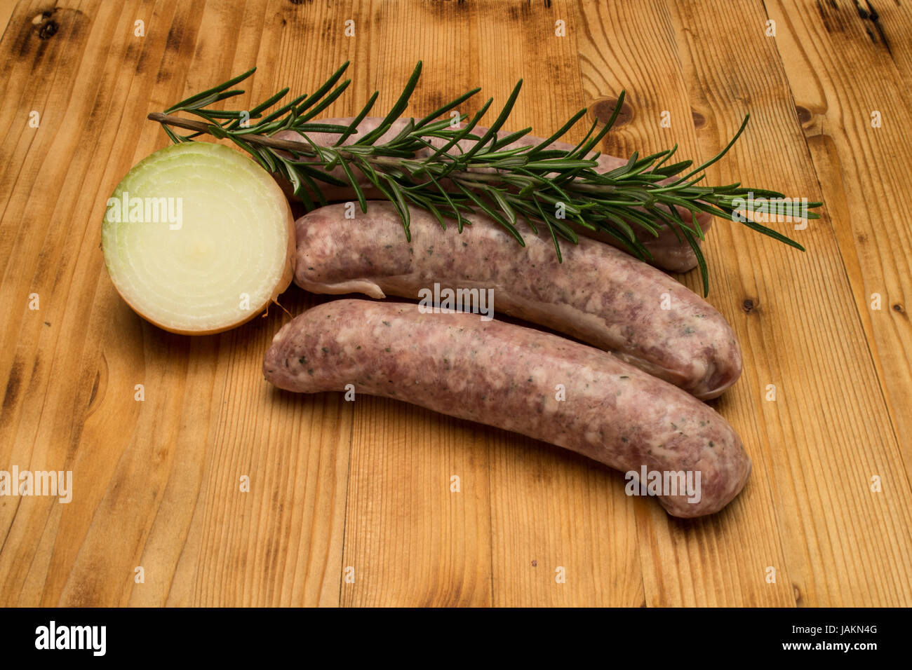 2 sausages on the old wooden board Stock Photo