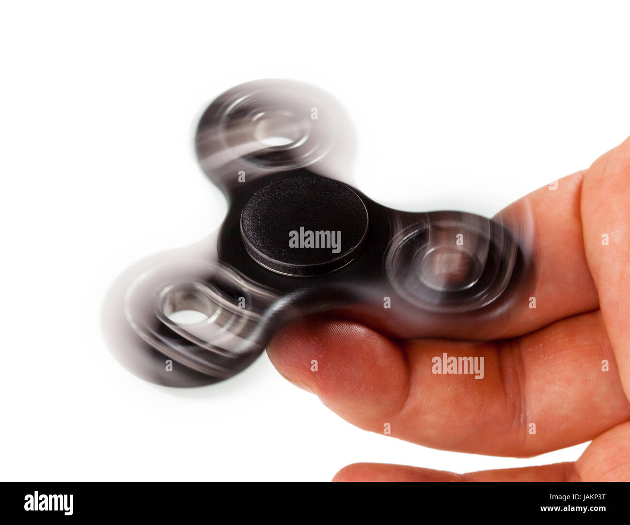 Palying with a Black Fidget Spinner isolated on white background Stock ...