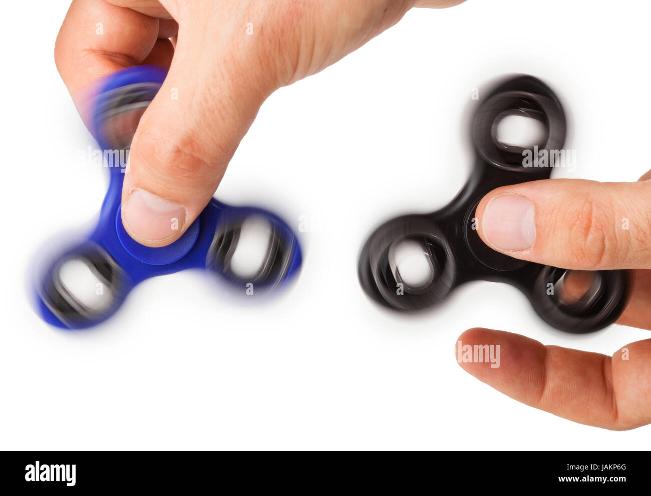 Playing with two Fidget Spinner isolated on white background Stock