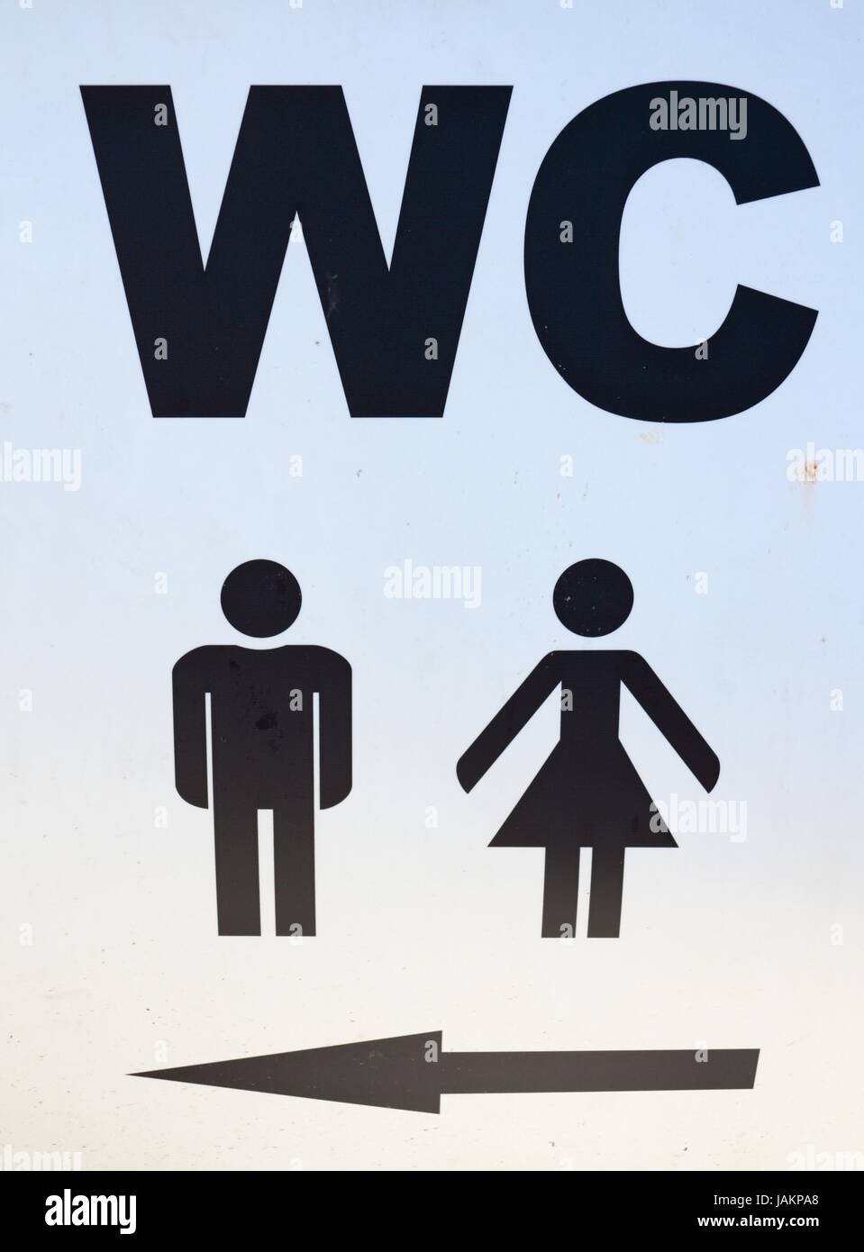 Men and women sign of public toilets with an arrow showing direction WC