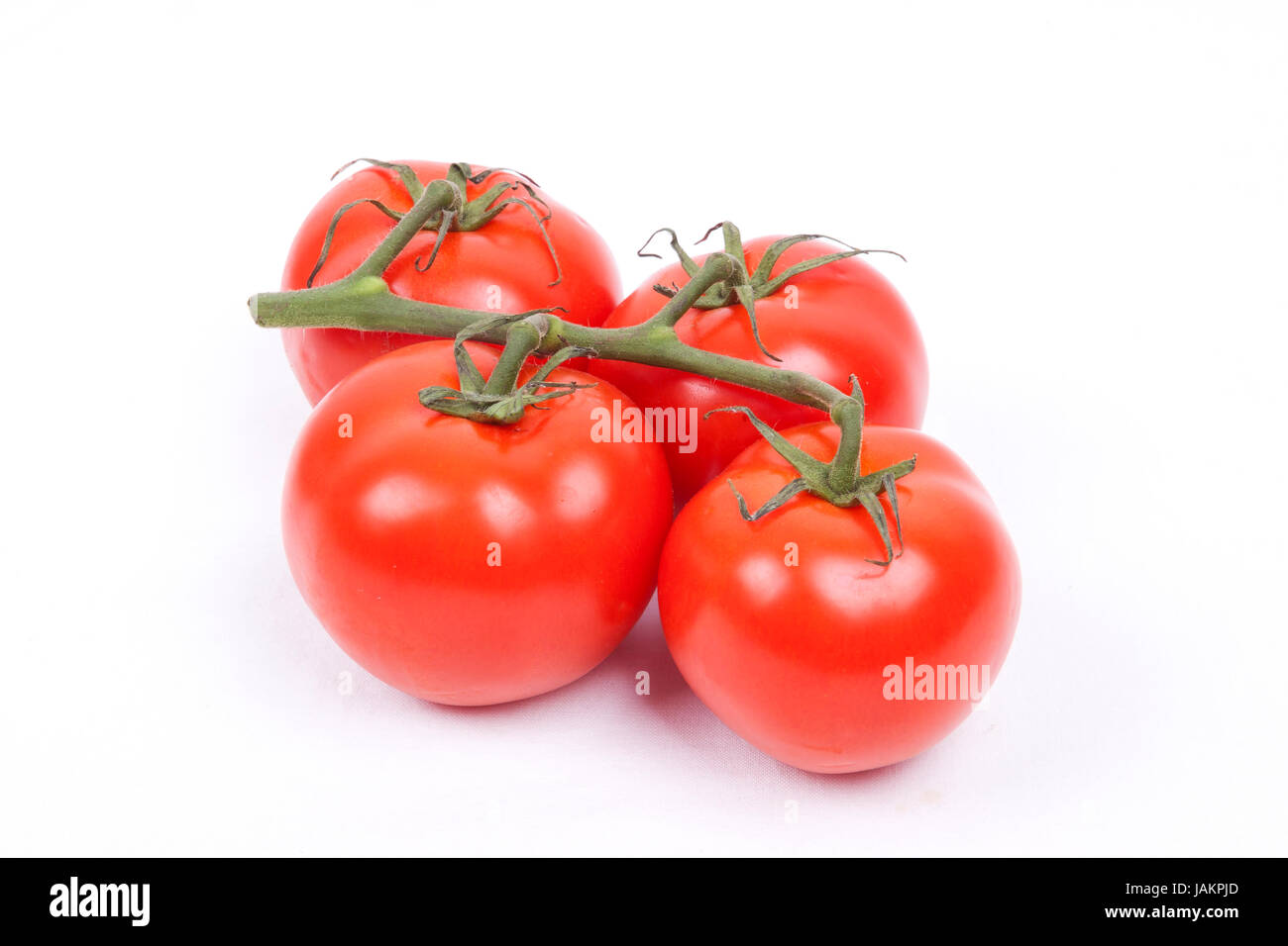 tomatos on a vine isolated on a white background Stock Photo - Alamy