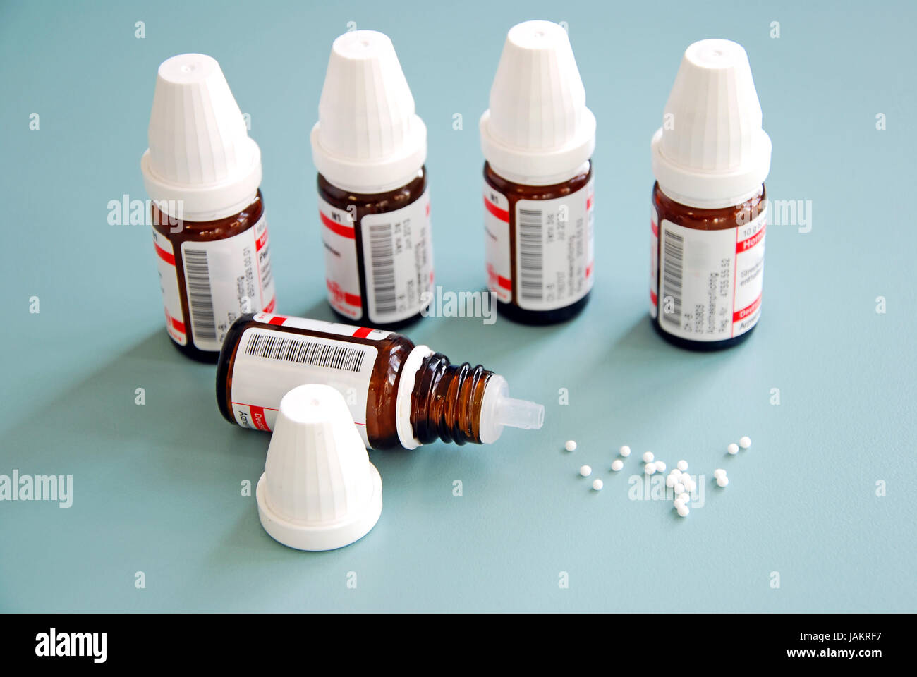 homeopathic globule pills and small bottles on a table Stock Photo