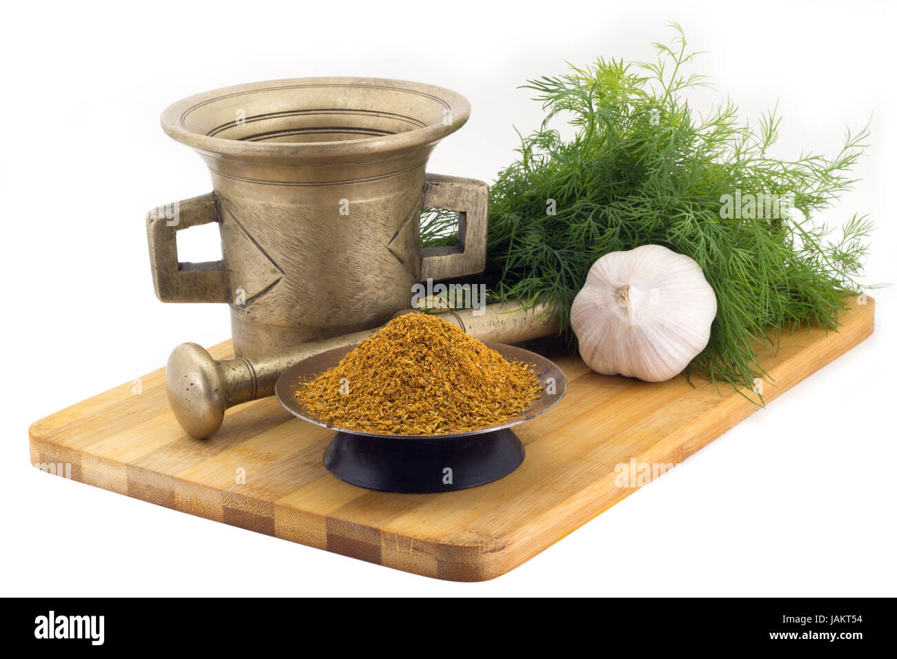 Still Life Spices, seasonning for pilaf,marigold staminas in a copper vase on a wooden board on a background of a stern stupa for grinding spices, bun Stock Photo