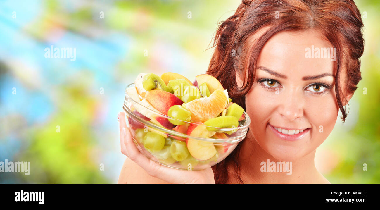 Young woman holding glass bowl with fruit salad Stock Photo Alamy