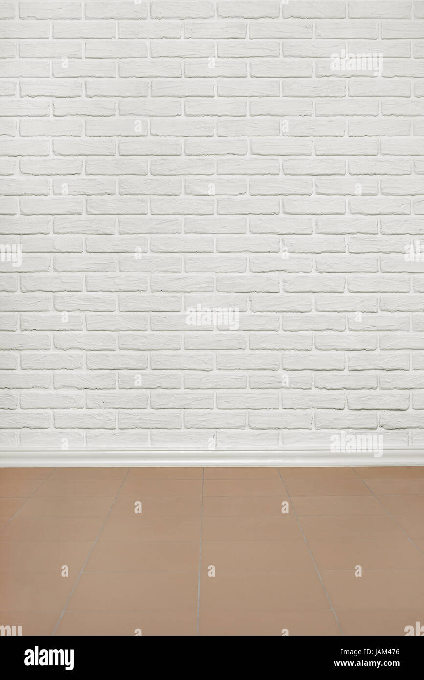 white brick wall with tiled floor, abstract background photo Stock