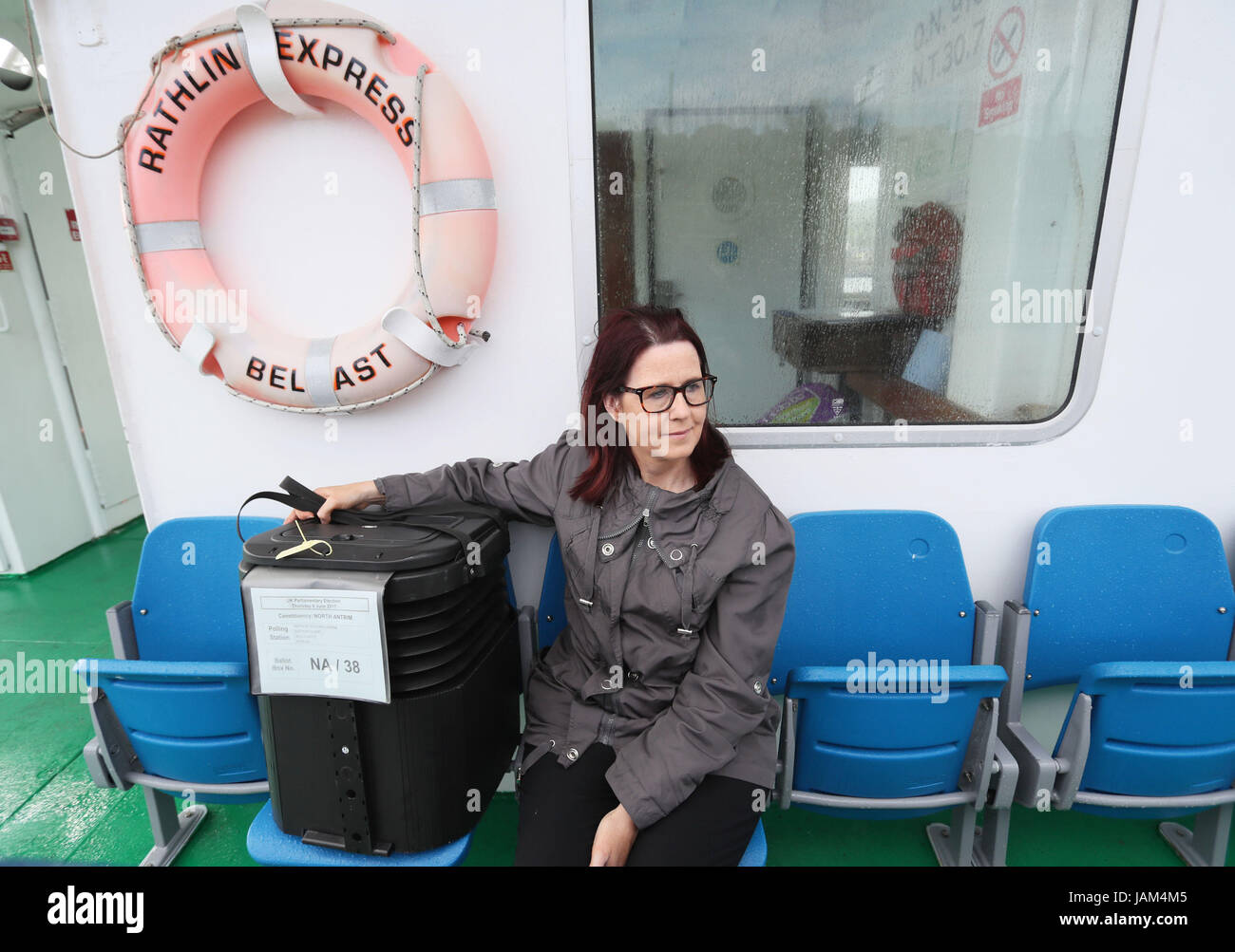 Mandy Hassan, assistant area electoral officer for north Antrim and mid Ulster, on route to Rathlin Island, off the north east coast of Northern Ireland, with the ballot box in which the island's population of just over 100 people will cast their votes during Thursday General Election. Stock Photo