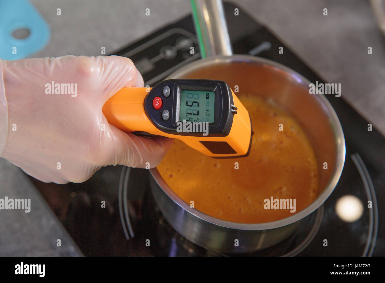 measuring the temperature of cream soup by digital thermometer Stock