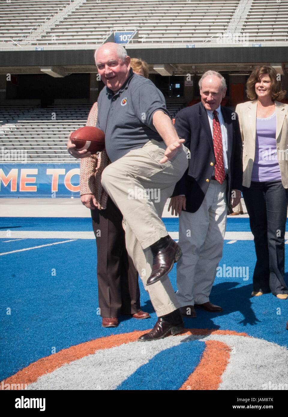 U.S. Agriculture Secretary Sonny Perdue strikes the American football trophy pose during a visit to at Boise State University June 2, 2017 in Boise, Idaho. Perdue, a former governor of Georgia, played football in college. Stock Photo