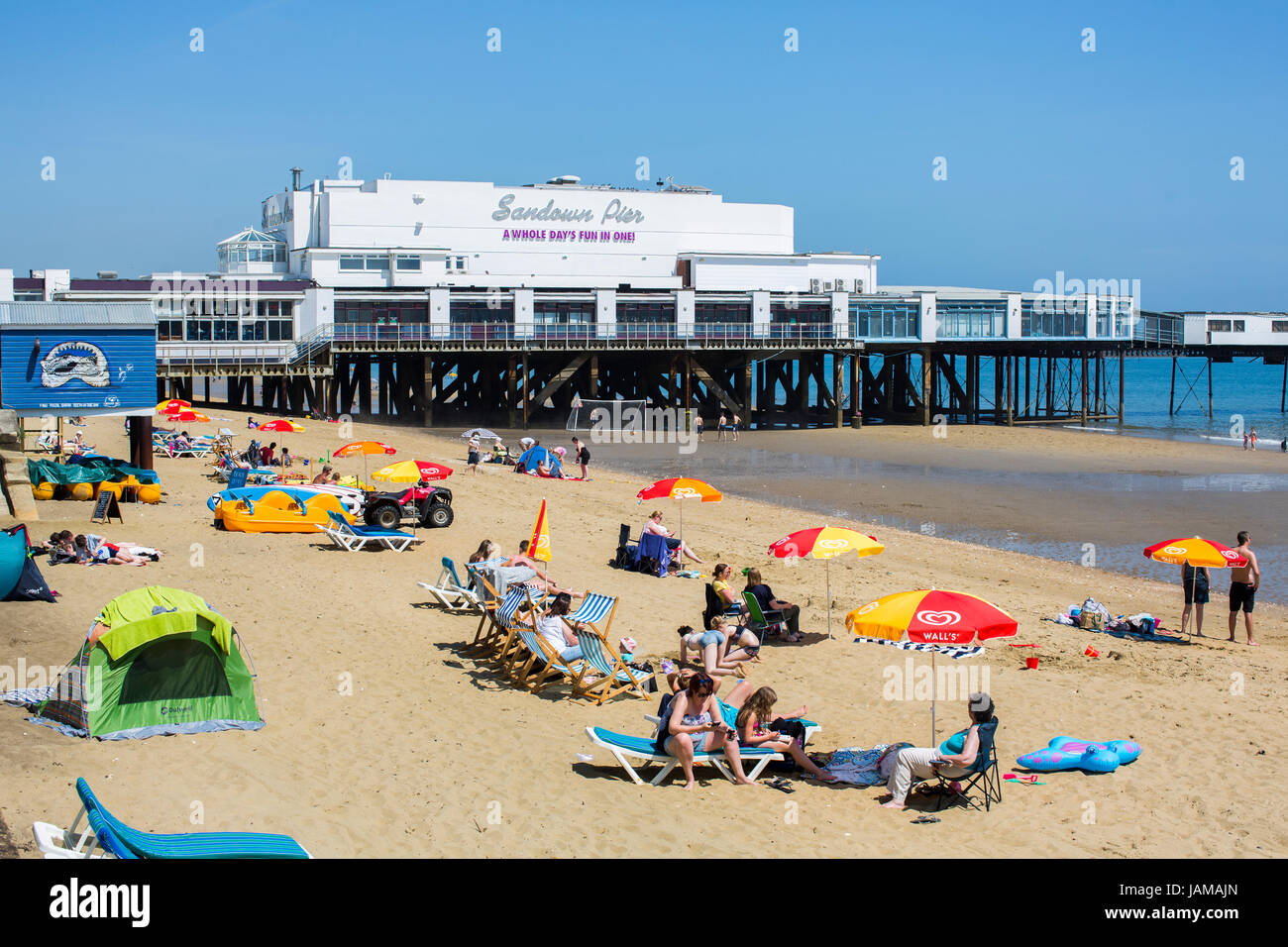 General view of Sandown Pier on the Isle of Wight with the busy beach