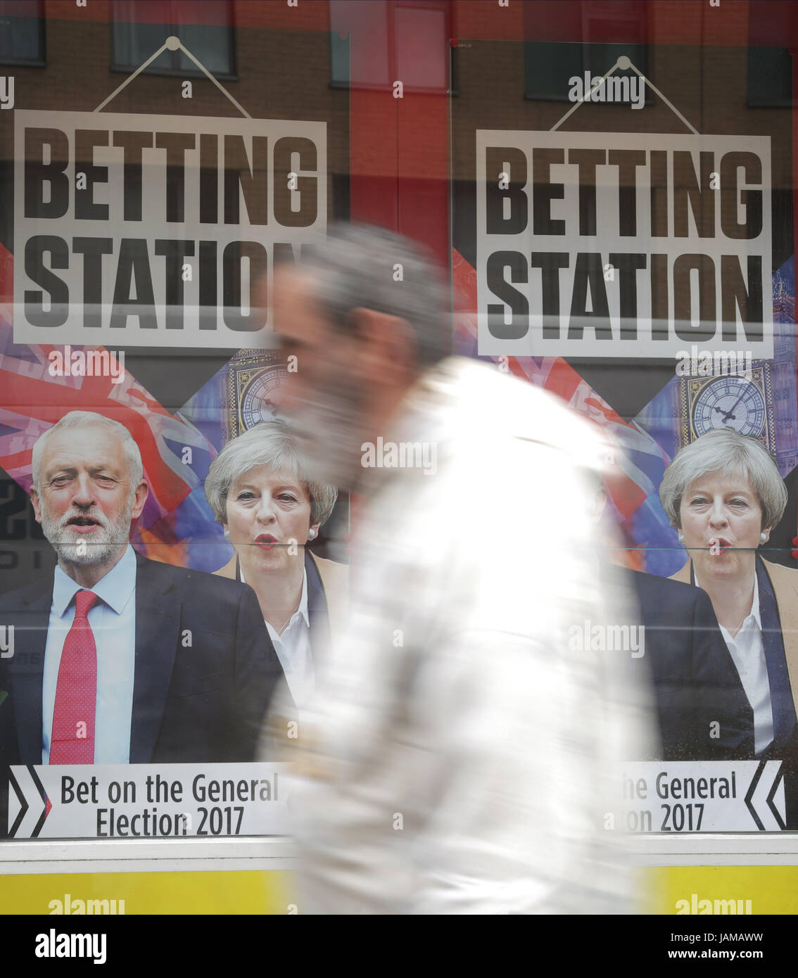 A man walks past a betting shop with a General Election promotion in the window, in London, as the leaders of Britain's biggest parties are criss-crossing the country in a whirlwind last-minute bid for votes ahead of General Election day on Thursday. Stock Photo