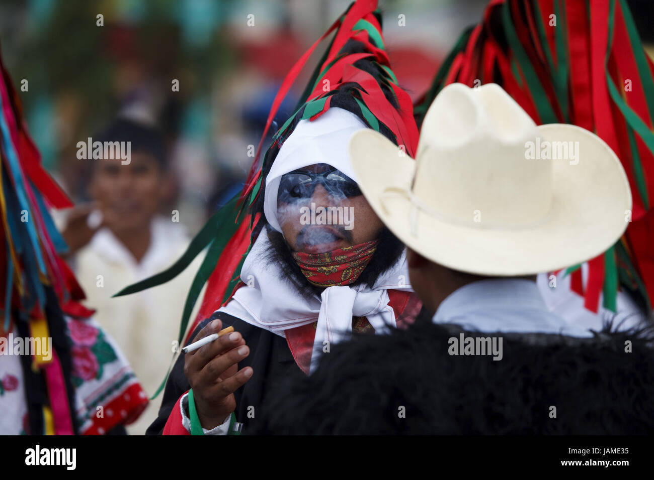 Mexico,Chiapas,San Juan Chamula,carnival,man,Maya,Mono,smoking, Stock Photo