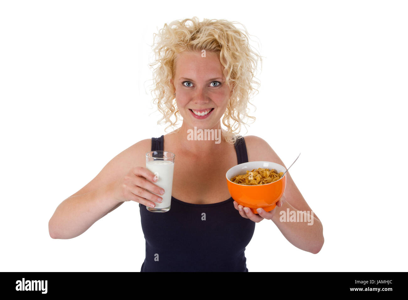 Junge Frau mit einem Glas Milch und einer Schale Cornflakes - freigestellt Stock Photo
