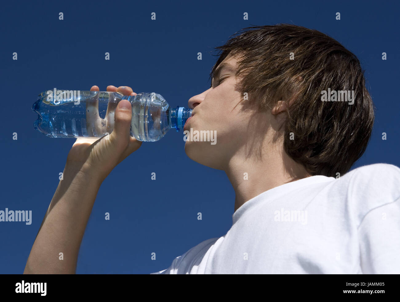 Teenagers,boy,water flask,thirst,drink,sky,blue,portrait,curled,people,T-shirt,flask,water,refreshment,cooling,season,summer,sunshine,tread,at the side, Stock Photo
