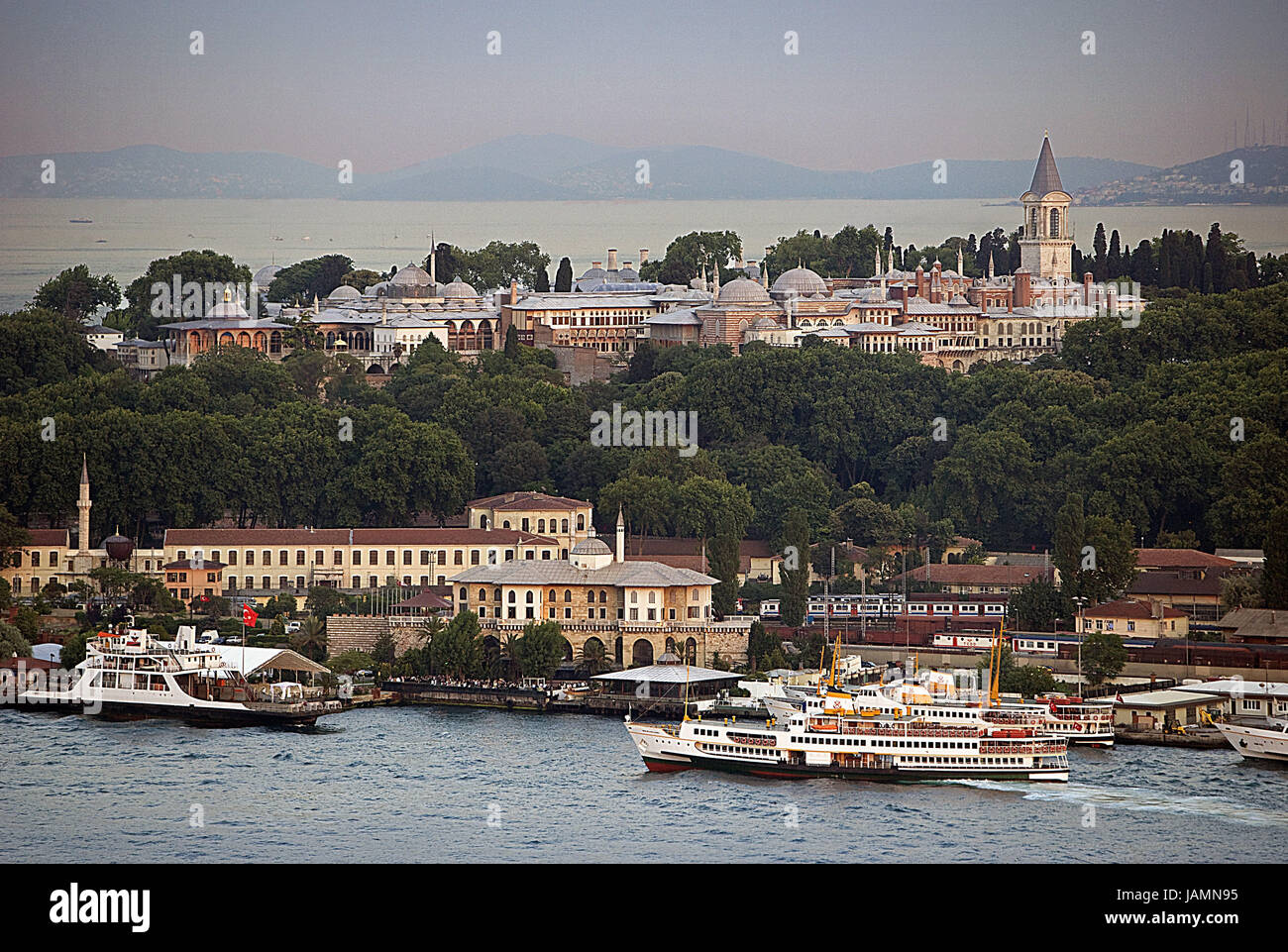 Turkey,Istanbul,town view,Topkapi palace,'the Golden Horn',evening,ships,town,city,metropolis,port,culture,input,gate,place of interest,person,tourism,towers,architecture,museum,palace building,houses,residential houses,hotels,the Bosporus,sea,navigation,tourism, Stock Photo