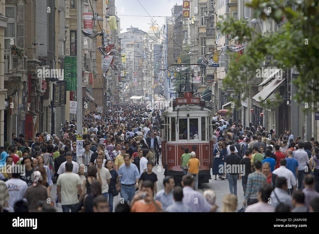 Turkey,Istanbul,part of town of Beyoglu,streetcar,pedestrian area,passer-by,town,city,metropolis,port,place of interest,tourism,architecture,lane,houses,shops,means of transportation,publicly,tram,person,pedestrian,crowd of people,outside, Stock Photo