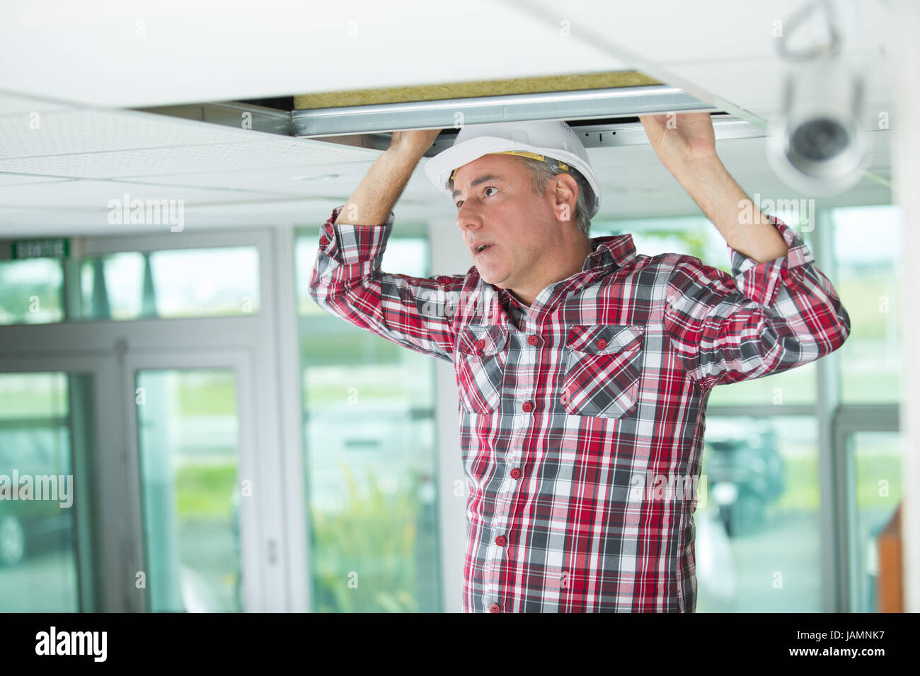 worker openning filter holder for air conditioning filter in ceiling