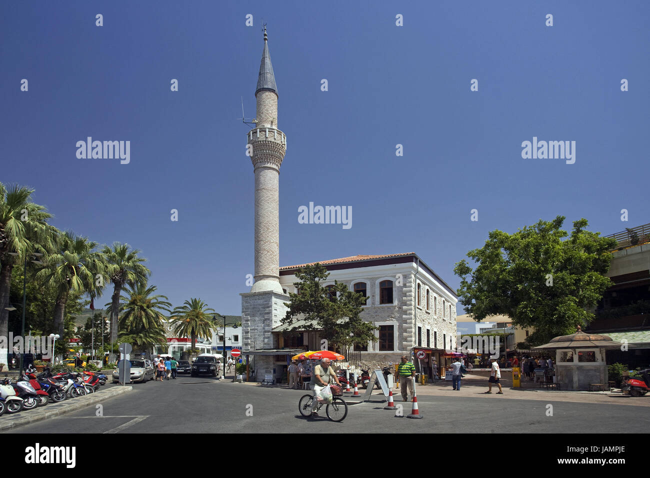 Turkey,Bodrum,Adiye mosque,minaret,street scene,passer-by,destination,town,place of interest,building,structure,architecture,faith,religion,Islam,church,sacred construction,trees,palms,people,pedestrians,outside,sunny, Stock Photo