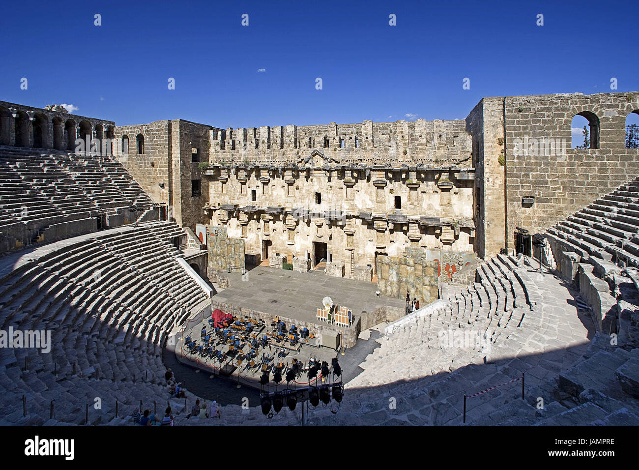 Turkey,Aspendos,amphitheatre,tourist,Mediterranean coast,ruin site,structure,theatre,remains,historically,old,antique,architecture,culture,place of interest,person,visitor,sightseeing,destination,tourism,film set,stage,orchestra,spectator's stand,ranks, Stock Photo