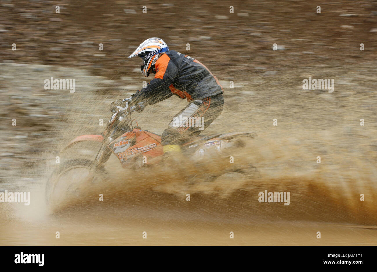 Moto crosses,motor sport,Austria,Styria,iron ore,motorcycle,driver,mud,inject,no model release,no property release,arch mountain rodeo,racing driver,moto cross driver,race,moto cross race,passage,race track,person,sport,sport,racing sport,speed,motion,drop,puddle, Stock Photo