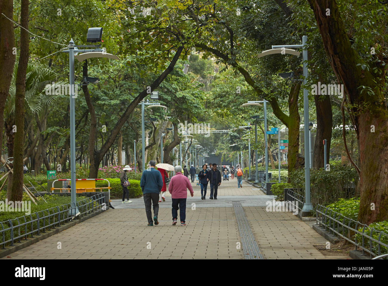 People walking through Victoria Park, Causeway Bay, Hong Kong, China Stock Photo