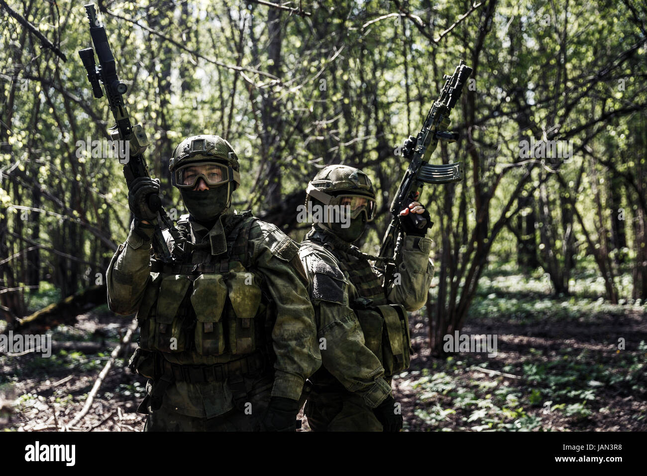 Soldiers with weapons on military mission in forest Stock Photo - Alamy