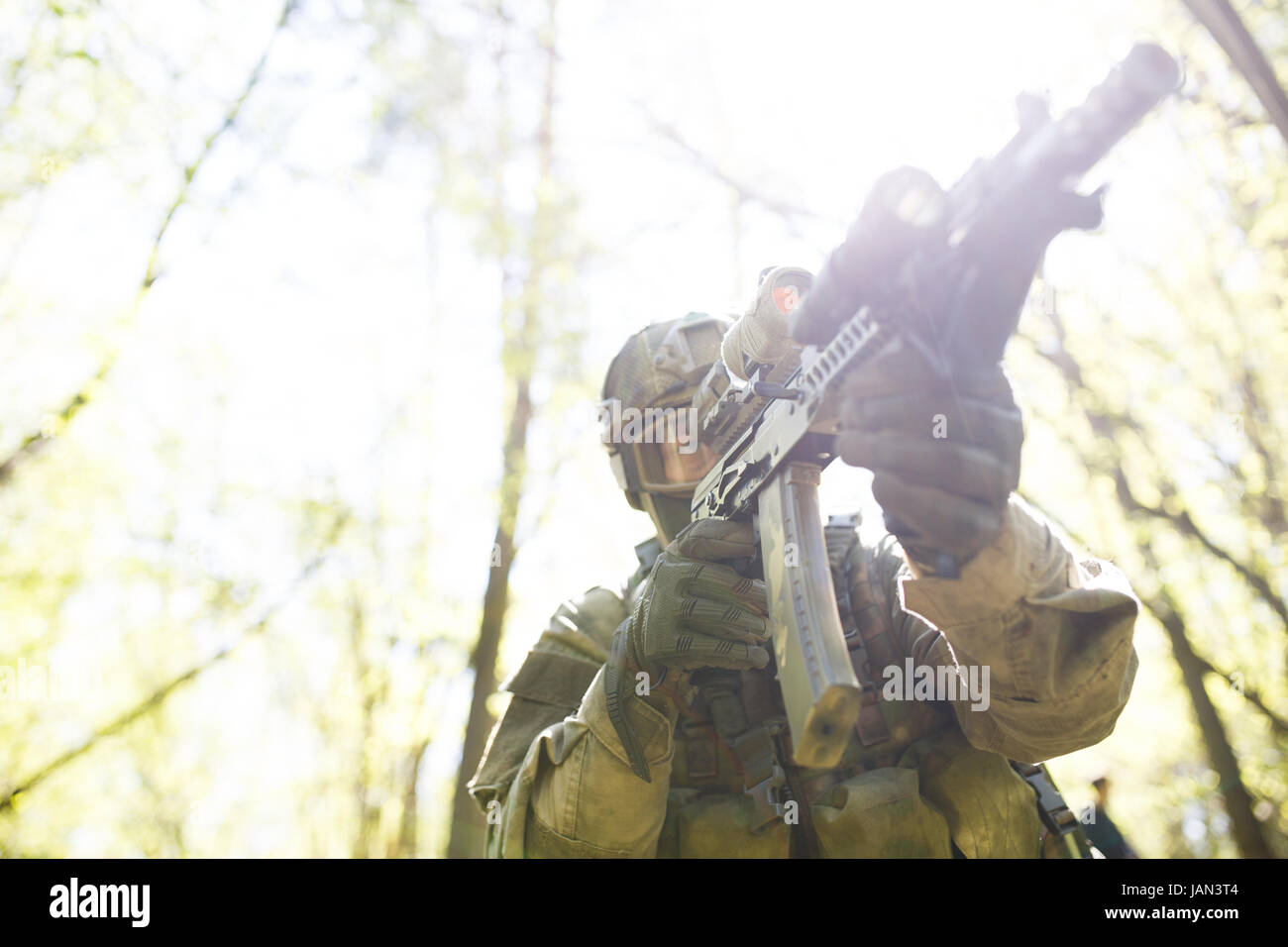 Photo of soldier in military operation in forest, photo below, sun ...