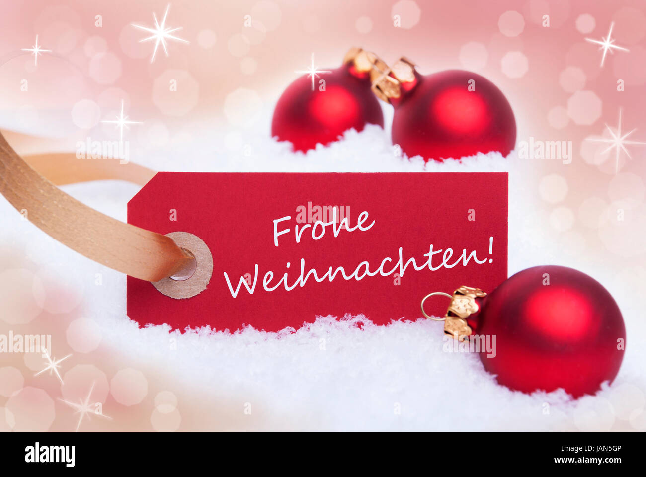 A Red Tag With the German Words Frohe Weihnachten Which Means Merry Christmas on it Stock Photo