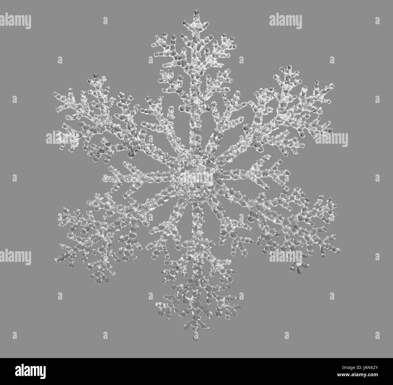 artificial clear snowflake isolated in grey back Stock Photo
