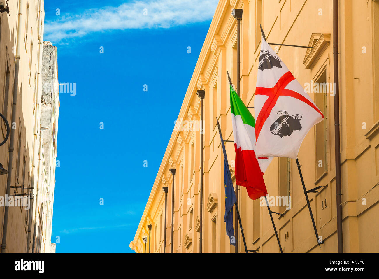 Castello Cagliari, a Sardinian and an Italian national flag sited in the Via Universita in the historic Castello quarter of Cagliari, Sardinia. Stock Photo