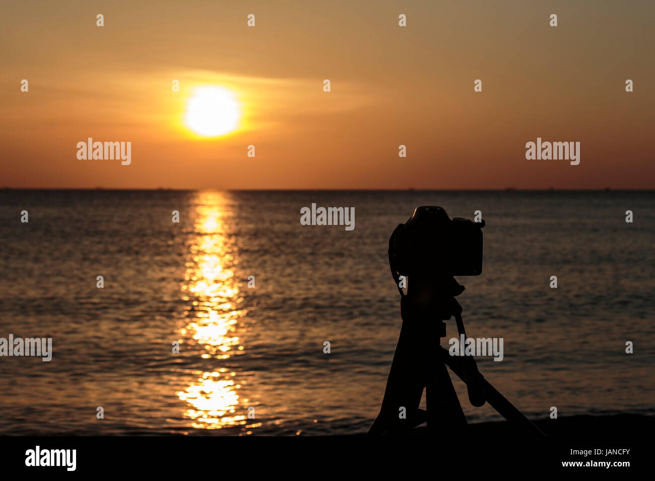 Camera on a tripod to take pictures of the sun and landscape Stock ...