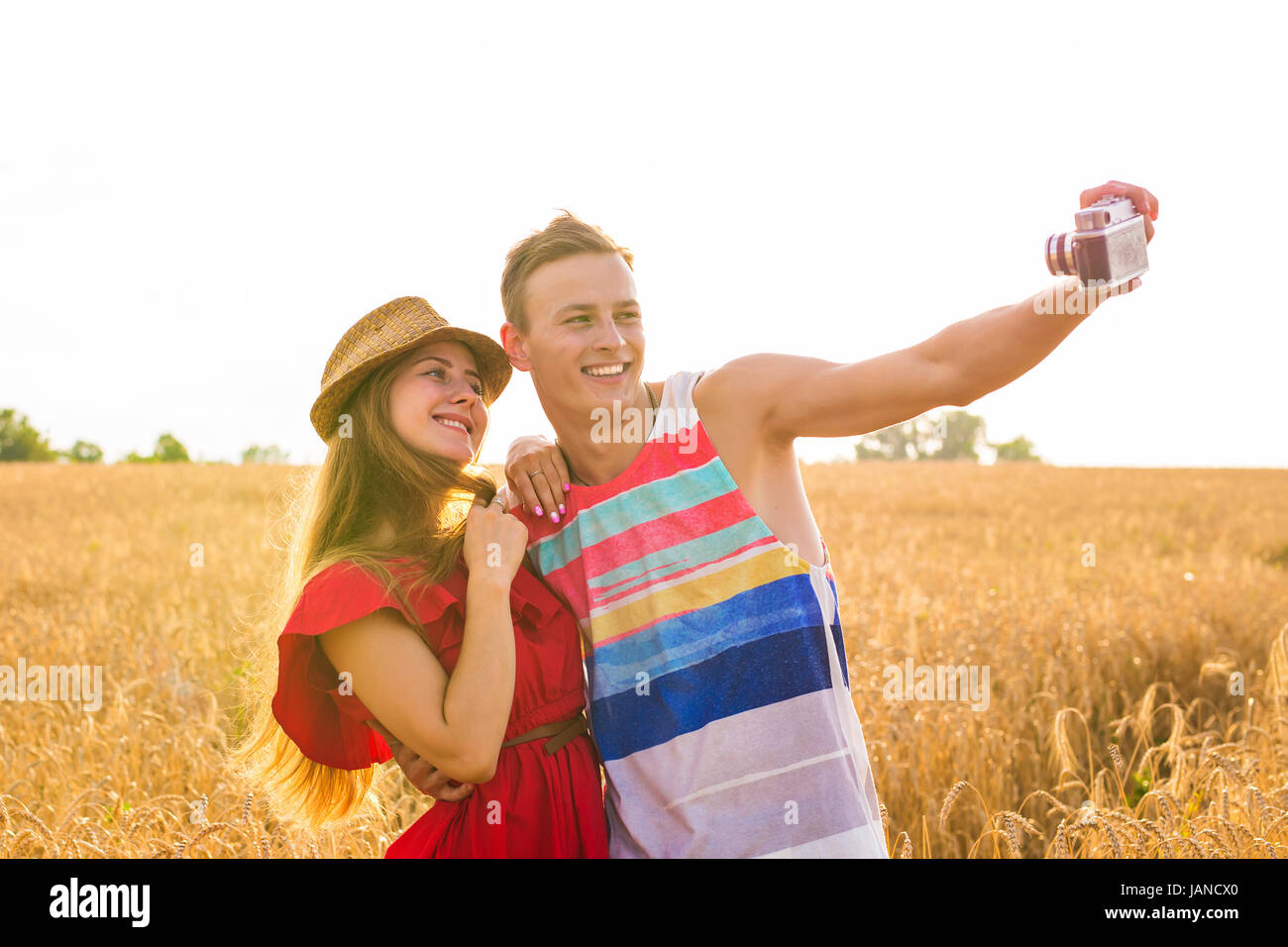 Young happy couple taking a selfie in the field Stock Photo - Alamy