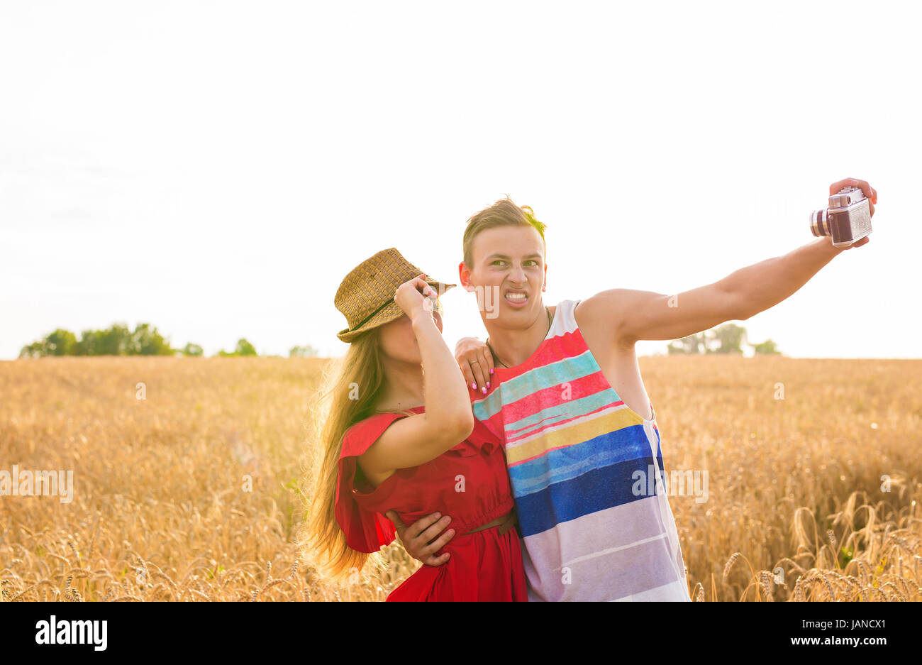 Young happy couple taking a selfie in the field Stock Photo - Alamy