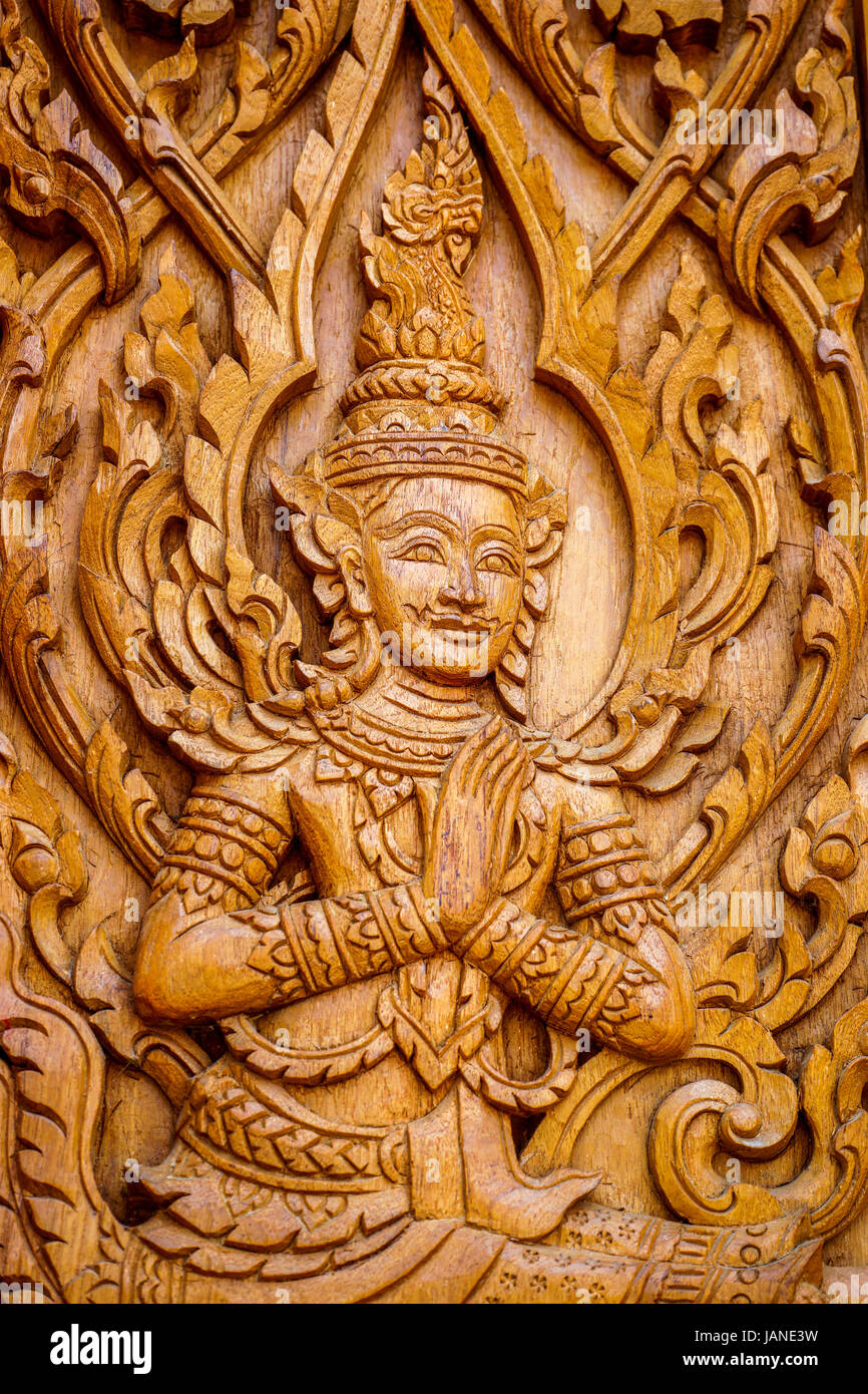 Traditional Thai Art in wood carving for decoration on Buddhist temple doors or windows. Stock Photo