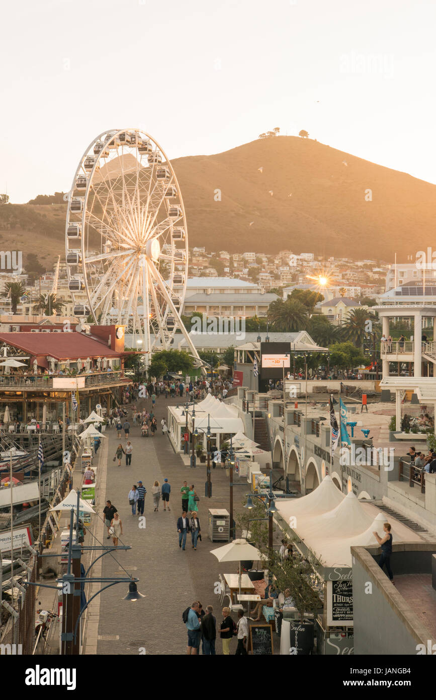 A bustling V & A waterfront showing the Cape Wheel and shops in Cape