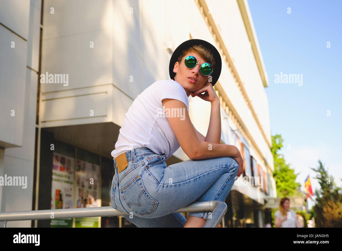 Close up portrait of female hipster with natural makeup and short haircut enjoying leisure time outdoors Stock Photo