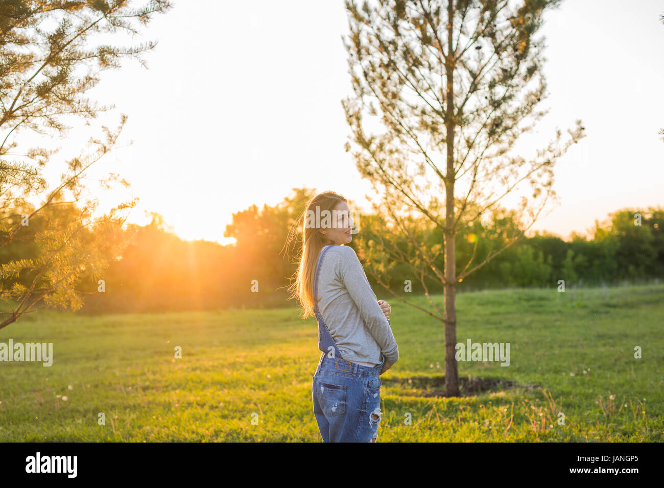 Pregnant woman hugging her belly outdoors Stock Photo - Alamy