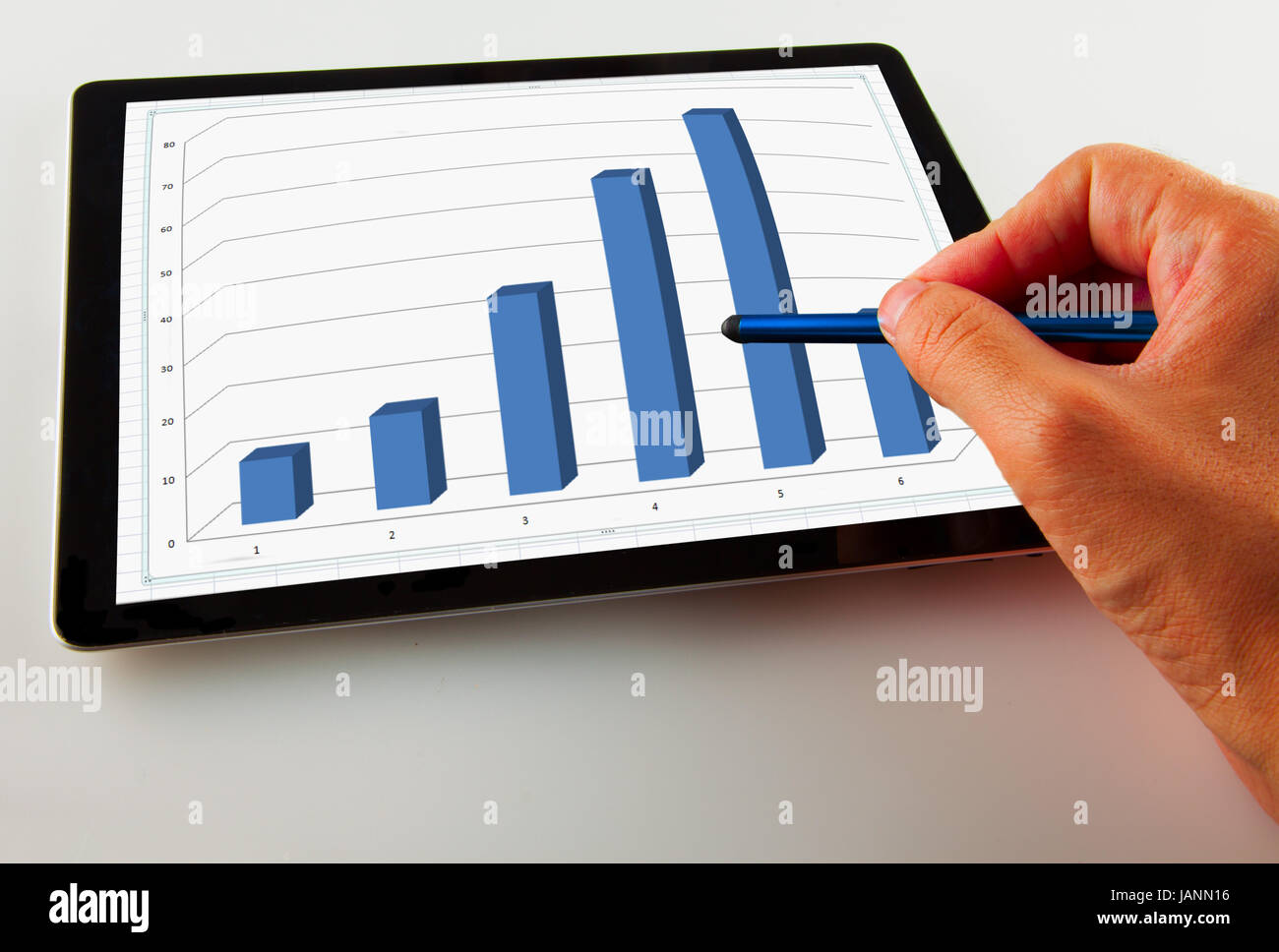 Male hand pointing a graph on a tablet Stock Photo