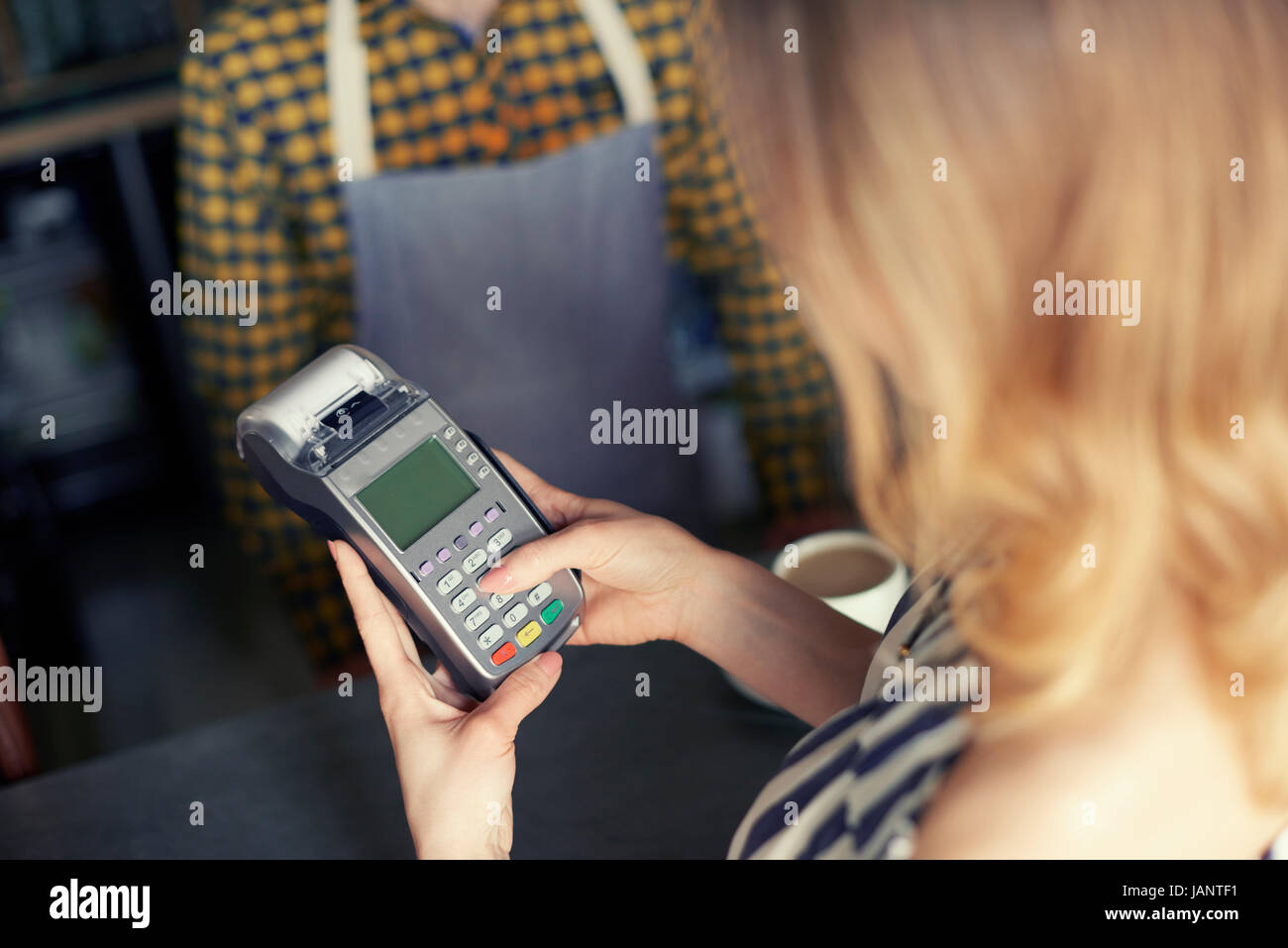 Customer using pin entry credit card reader Stock Photo Alamy