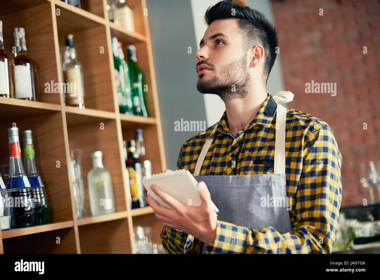 Bartender doing an inventory of the products Stock Photo