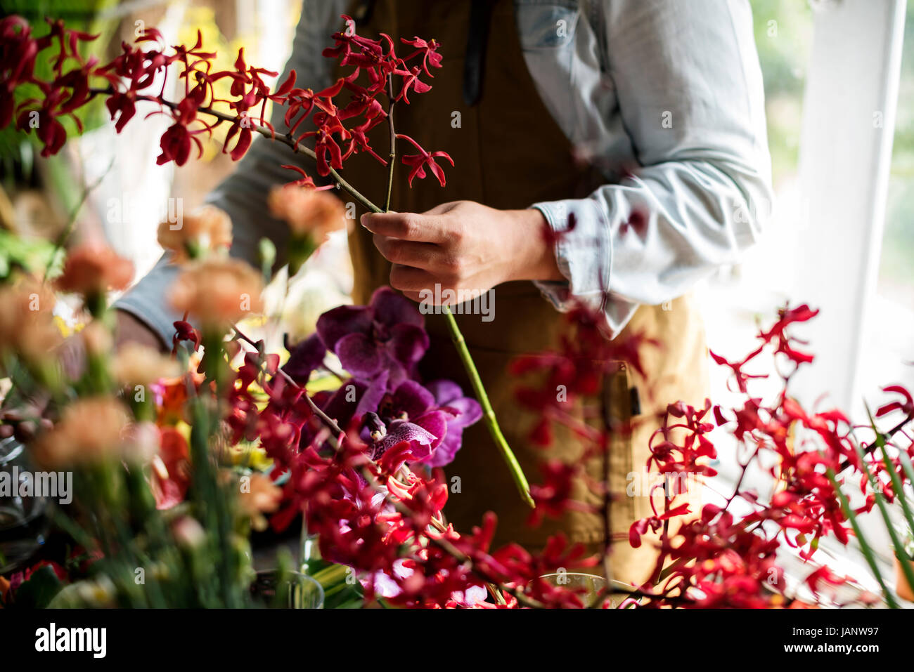 Flowerist working in the flower shop vintage style Stock Photo - Alamy