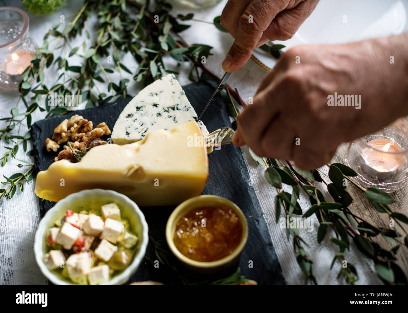 People Hands With Cutlery Getting Cutting Cheese Stock Photo