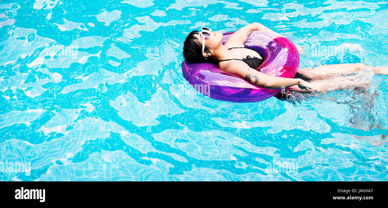 Asian woman floating in the swimming pool with inflatable tube Stock ...