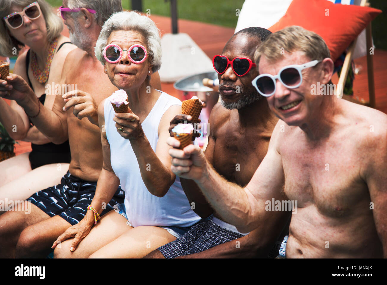 Group of diverse senior adults eating ice cream together Stock Photo